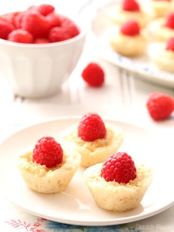 Raspberry Coconut Mini Pies brings a bit of elegance to dessert tables with homemade pie crust, coconut pudding, and sweet whole raspberries.