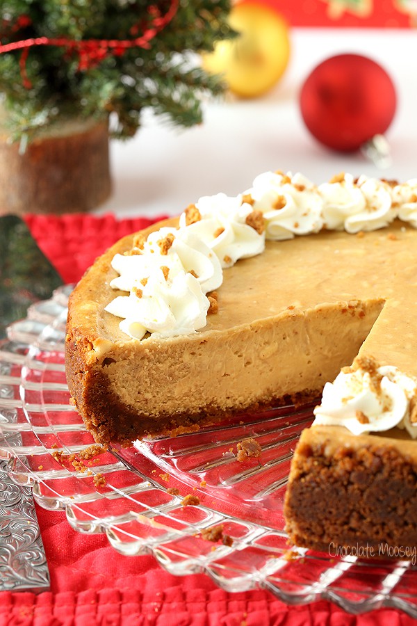 Gingerbread cheesecake on glass plate with slice missing