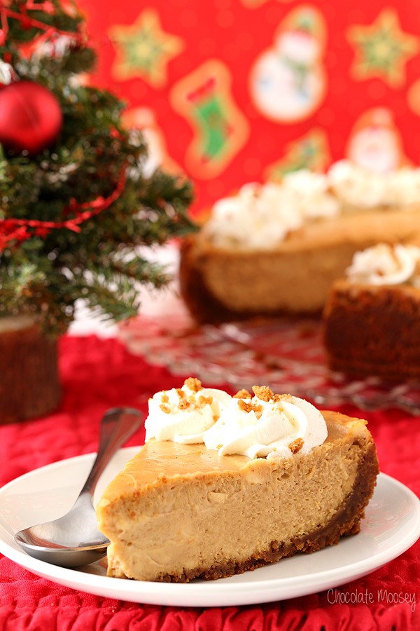 Slice of gingerbread cheesecake on a white plate with red Christmas background