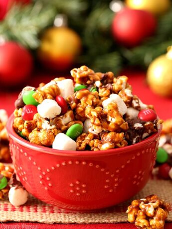 Christmas Popcorn in red bowl with mini marshmallows, M&Ms, and chocolate
