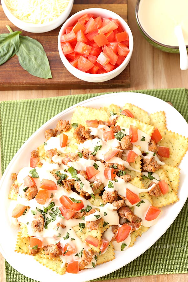 Italian Nachos with hot sausage, mozzarella cheese, tomatoes, basil, and Pasta Chips