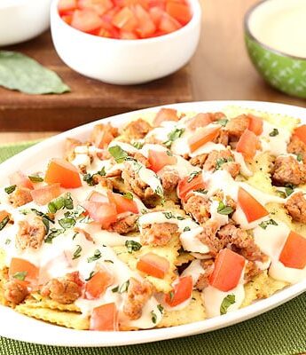 Italian Nachos with hot sausage, mozzarella cheese, tomatoes, basil, and Pasta Chips