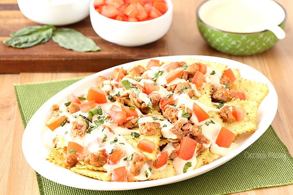 Italian Nachos with hot sausage, mozzarella cheese, tomatoes, basil, and Pasta Chips