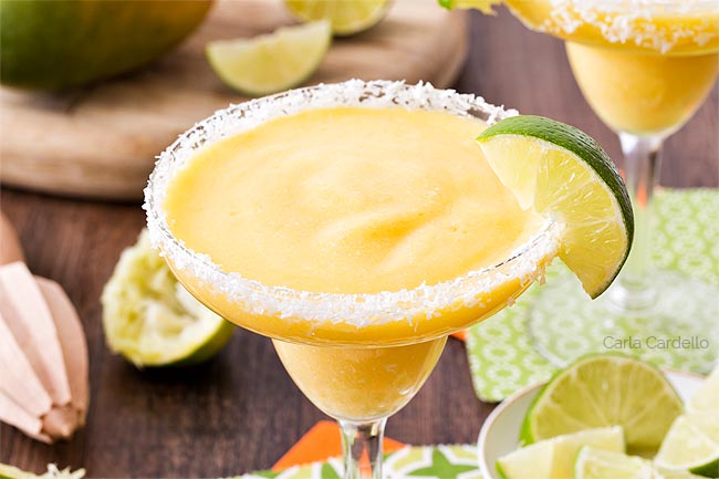 Close up of mango margarita with lime slice