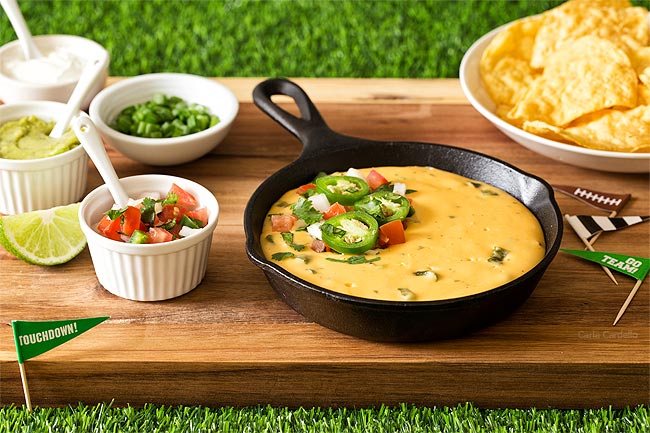 Nacho Cheese Dip on brown cutting board