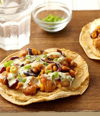Barbecue chicken and corn on top of oven baked tostadas with hummus