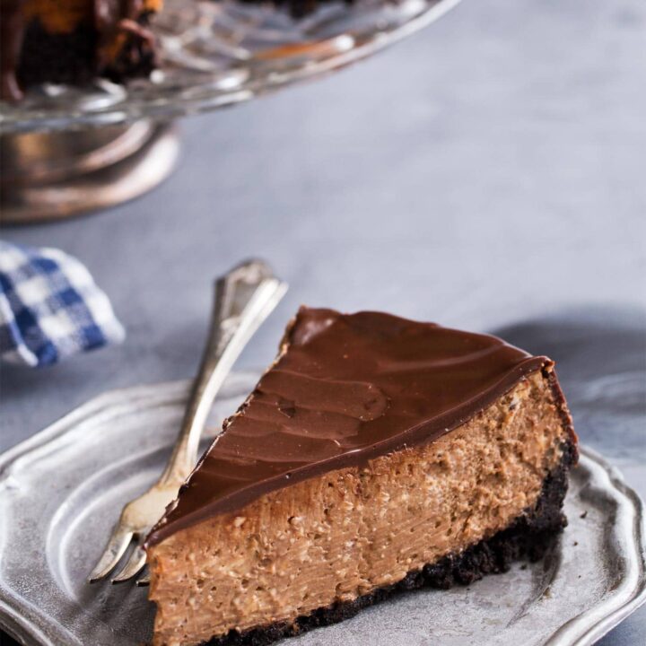 Slice of chocolate cheesecake with oreo crust