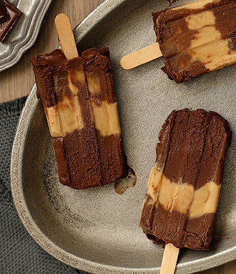 Chocolate Peanut Butter Fudgesicles that taste like eating a peanut butter cup on a stick