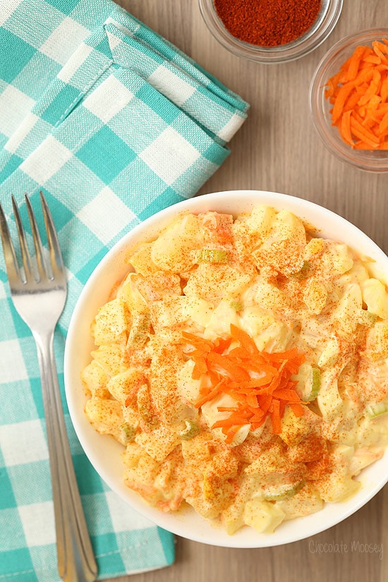 Amish potato salad in a white bowl with turquoise linen