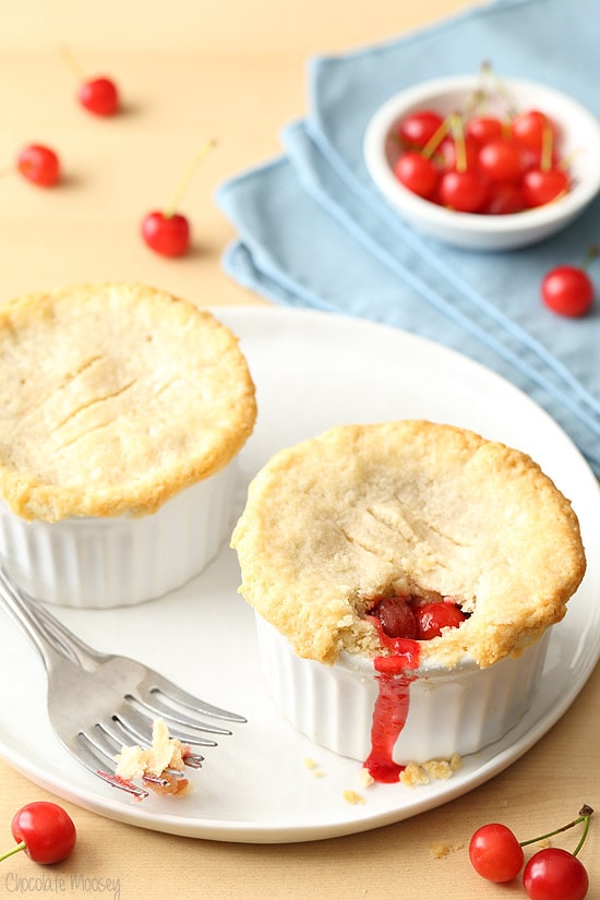 Two mini cherry pies in ramekins