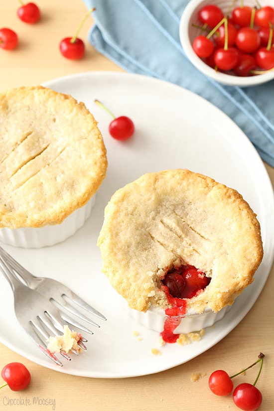 Two mini cherry pies on white plate