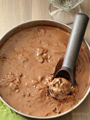 German chocolate ice cream in a round pan with ice cream scooper