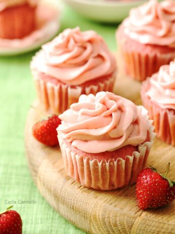 Strawberry cupcakes on wooden board
