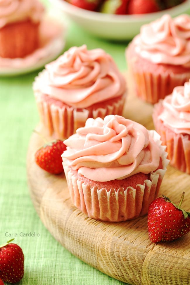 Strawberry cupcakes on wooden board