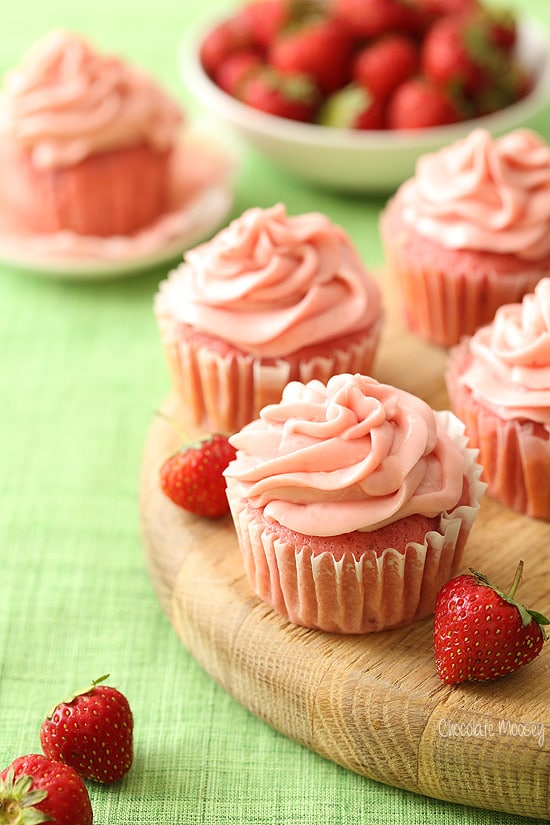 Strawberry cupcakes on wooden cheese board