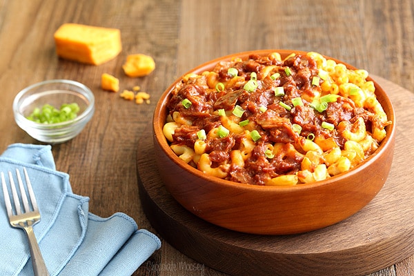 Mac and cheese with pulled pork in brown bowl