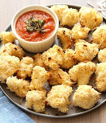 Coconut Crusted Baked Cauliflower Bites with homemade marinara sauce