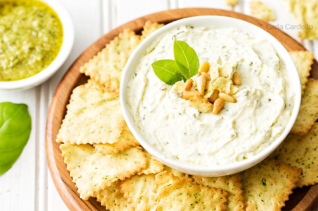 Pesto Dip in white bowl with chips