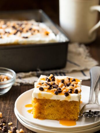 Slice of pumpkin poke cake on white plate