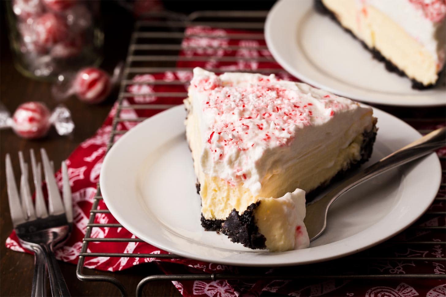 Slice of candy cane cheesecake with bite taken out