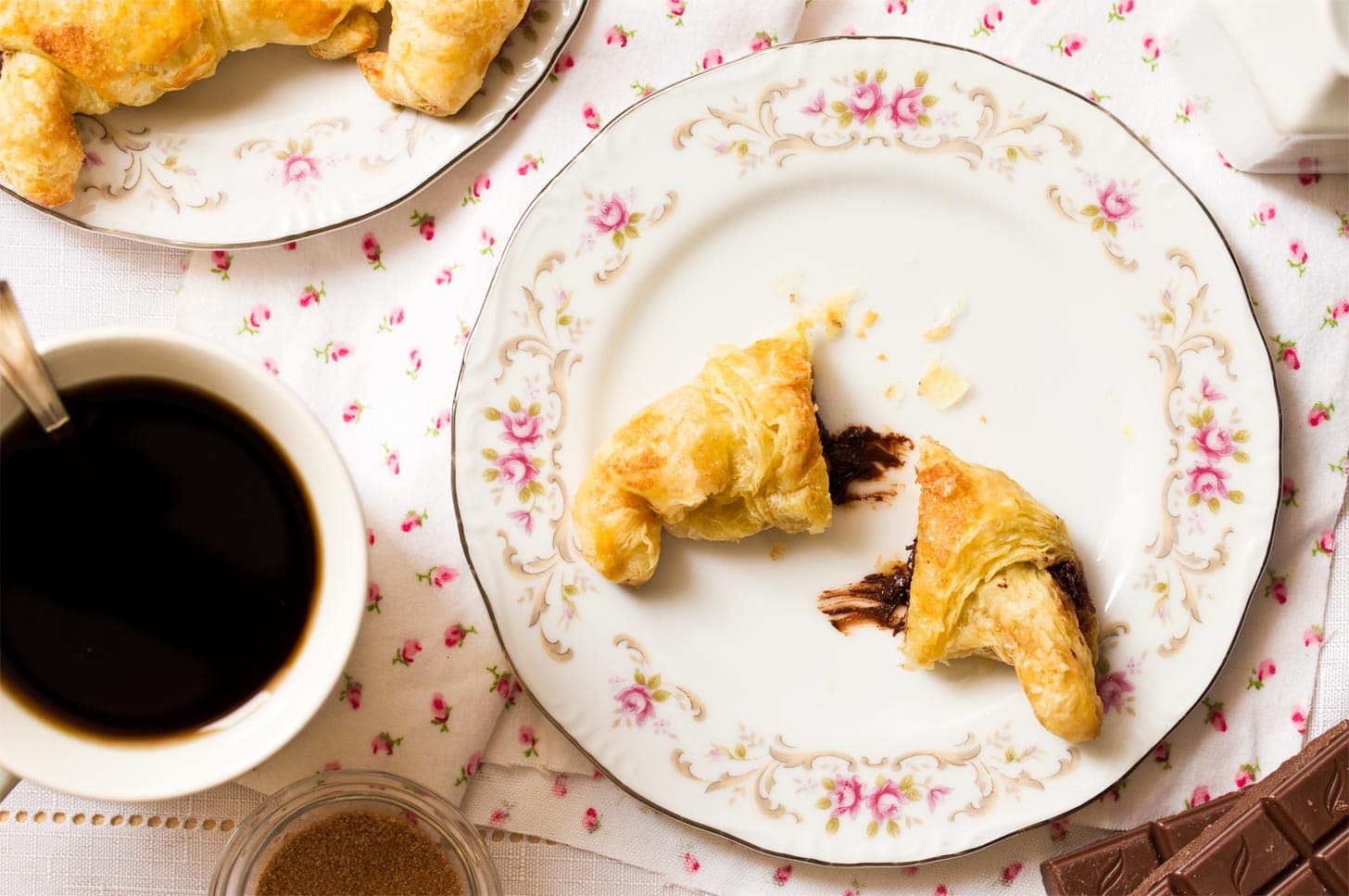 Small batch croissants cut in half with chocolate melting out