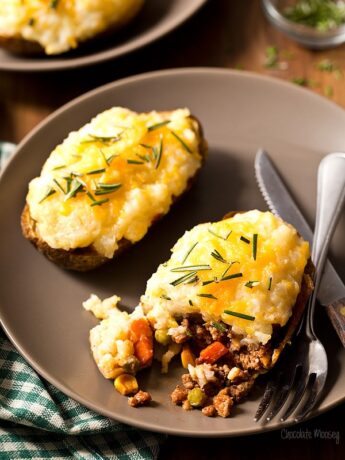 Shepherd's Pie Baked Potatoes cut open on a plate
