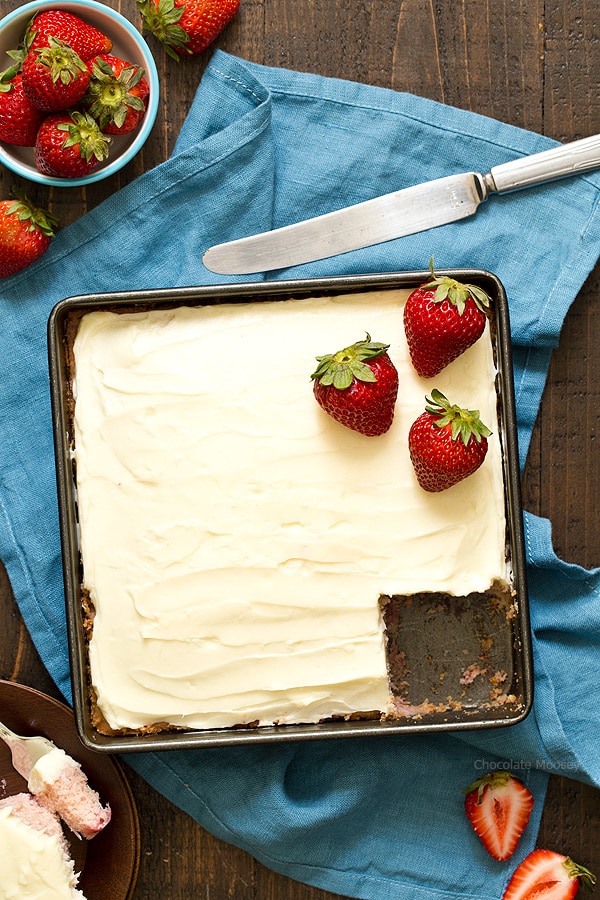 This fresh strawberry snack cake from scratch with homemade cream cheese frosting is made in an 8x8 pan without cake mix or Jello. Its natural pink color comes from fresh strawberries.