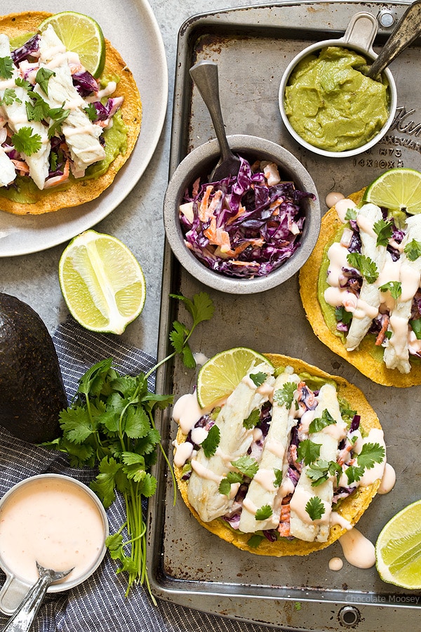 Sweet Chili Fish Tostadas topped with guacamole, sweet chili slaw, and flaky white fish