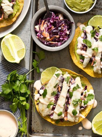 Sweet Chili Fish Tostadas topped with guacamole, sweet chili slaw, and flaky white fish make an easy summertime meal.