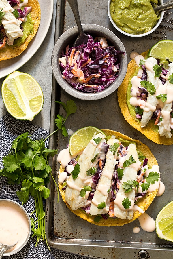 Sweet Chili Fish Tostadas topped with guacamole, sweet chili slaw, and flaky white fish make an easy summertime meal.