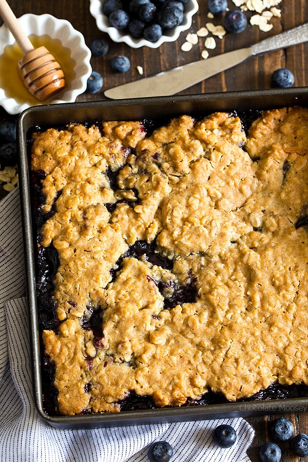 Soft, moist, and reminiscent of oatmeal cookies, Honey Blueberry Oatmeal Bars are filled with a homemade blueberry honey jam without pectin.