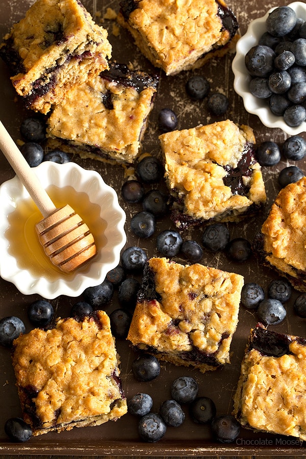 Soft, moist, and reminiscent of oatmeal cookies, Honey Blueberry Oatmeal Bars are filled with a homemade blueberry honey jam without pectin.