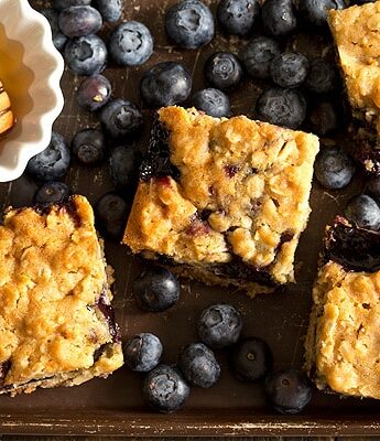 Soft, moist, and reminiscent of oatmeal cookies, Honey Blueberry Oatmeal Bars are filled with a homemade blueberry honey jam without pectin.