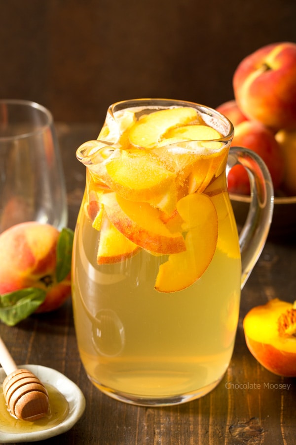Summer is for sipping sangria: Peach Honey Sangria made with white wine, fresh peaches, and honey