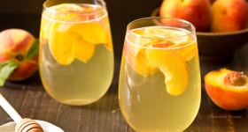 Summer is for sipping sangria: Peach Honey Sangria made with white wine, fresh peaches, and honey