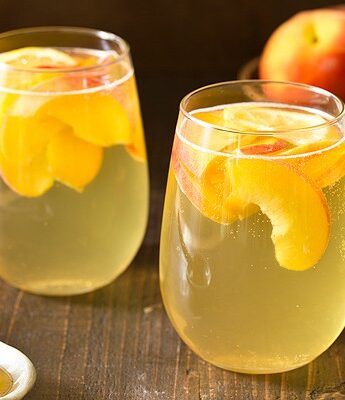Summer is for sipping sangria: Peach Honey Sangria made with white wine, fresh peaches, and honey