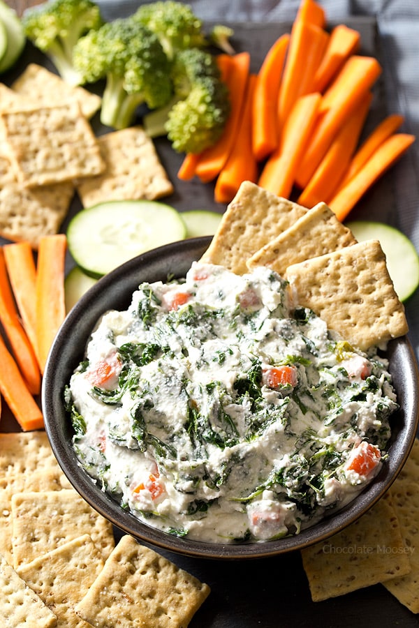 Cottage cheese spinach dip in bowl with crackers