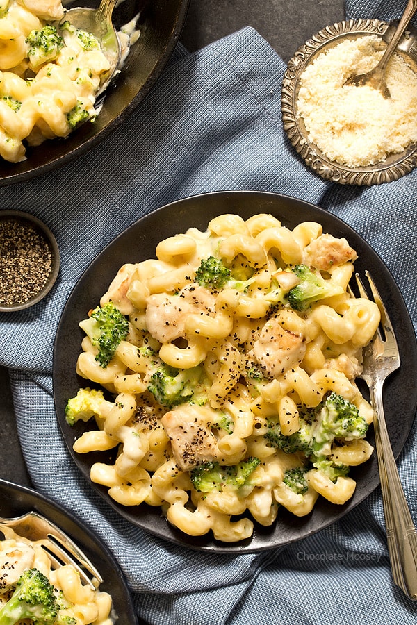 Alfredo mac and cheese on black plate with fork