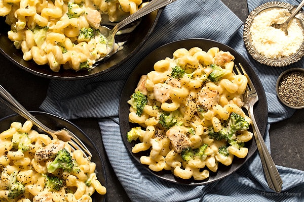 chicken broccoli alfredo pasta on black plate with fork