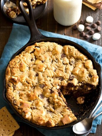 The taste of s'mores right from your oven! Peanut Butter S'mores Chocolate Chip Skillet Cookie combines graham crackers, toasted marshmallows, chocolate chips, and peanut butter into one heavenly dessert.