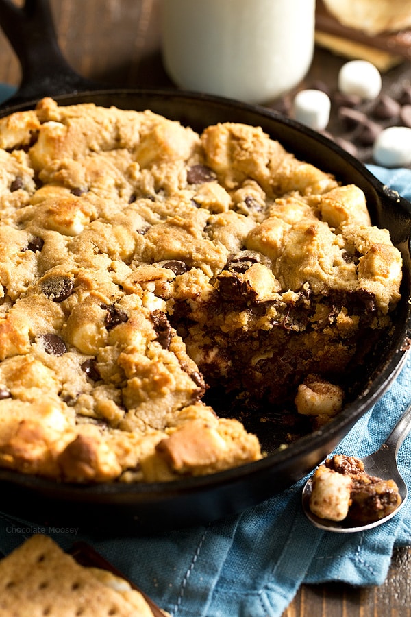 The taste of s'mores right from your oven! Peanut Butter S'mores Chocolate Chip Skillet Cookie combines graham crackers, toasted marshmallows, chocolate chips, and peanut butter into one heavenly dessert.