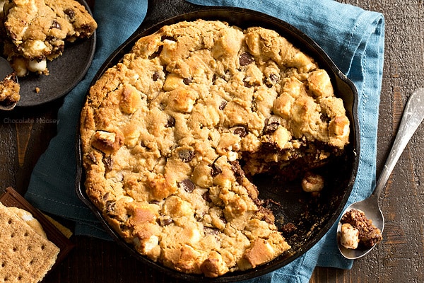 The taste of s'mores right from your oven! Peanut Butter S'mores Chocolate Chip Skillet Cookie combines graham crackers, toasted marshmallows, chocolate chips, and peanut butter into one heavenly dessert.