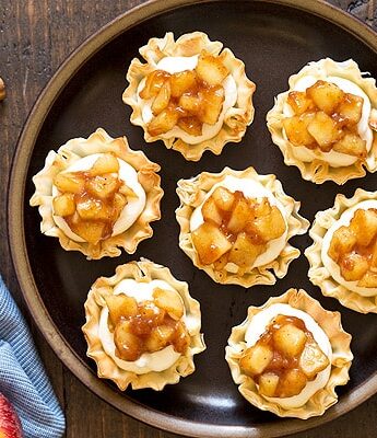 Get your apple pie fix in half the time with these No Bake Apple Pie Cheesecake Phyllo Cups. No need to roll out pie dough or spend time baking the cheesecake filling. Just fill pre-made phyllo cups and serve.