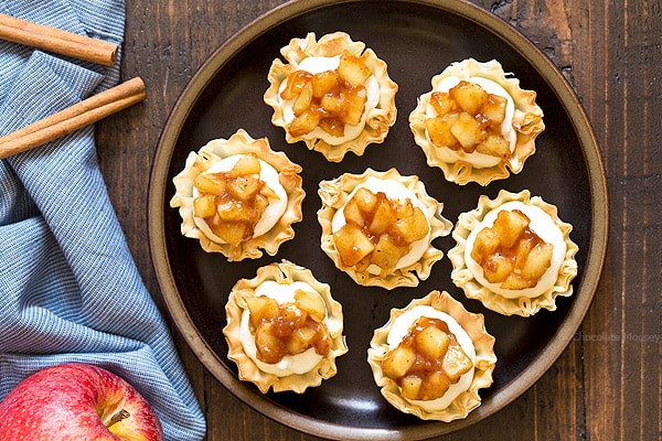 Get your apple pie fix in half the time with these No Bake Apple Pie Cheesecake Phyllo Cups. No need to roll out pie dough or spend time baking the cheesecake filling. Just fill pre-made phyllo cups and serve.