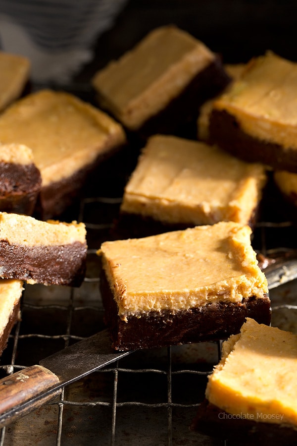 Serving pumpkin cheesecake brownie with knife