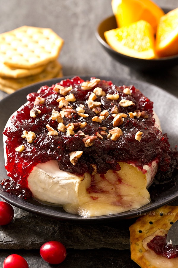 Cranberry Baked Brie oozing out onto a plate