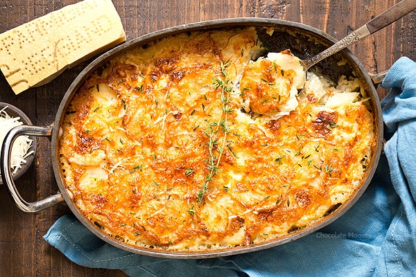 Garlic Parmesan Au Gratin Potatoes in casserole dish with spoon