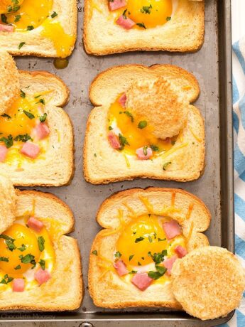 Close up of baked eggs in toast with ham and cheese
