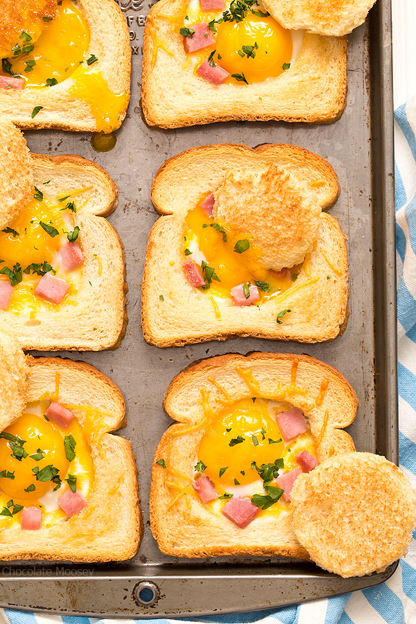Close up of baked eggs in toast with ham and cheese