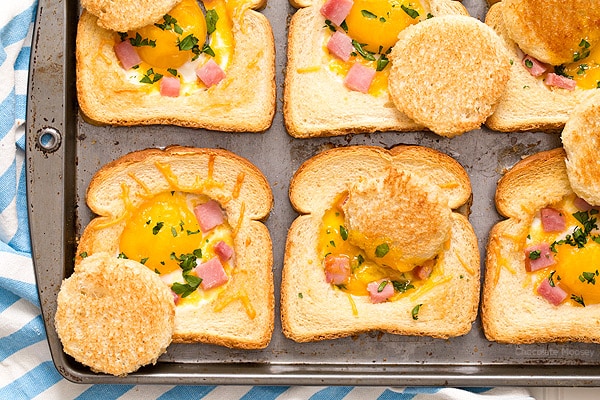 Close up of baked eggs in toast with ham and cheese